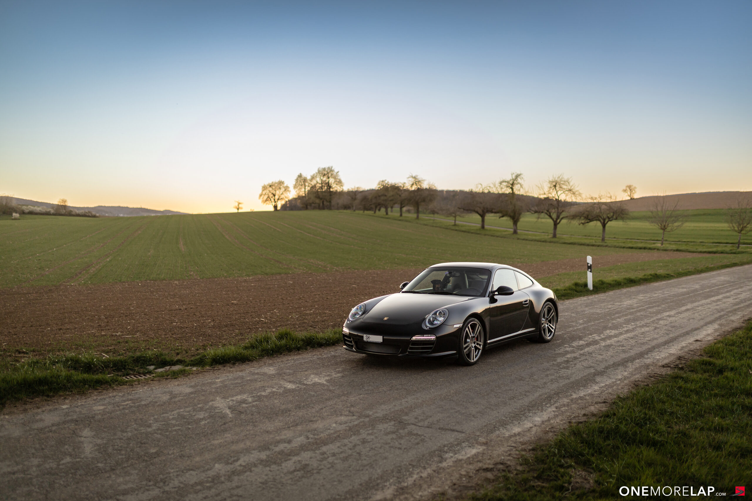 Porsche 997.2 Carrera 4S at sunset on a Swiss country road